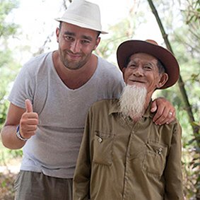 Rehahn poses for photos with his 91-year-old neighbor in Hoi An, one of his favorite models