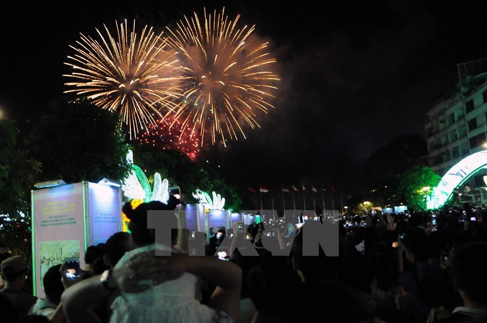 The crowd watch fireworks from Nguyen Hue street