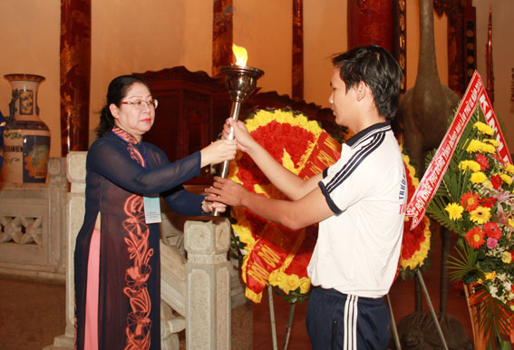 Phó trưởng ban chỉ đạo, Giám đốc Sở GD-ĐT Huỳnh Lệ Giang trao ngọn đuốc được lấy lửa từ Văn miếu Trấn Biên cho học sinh Trường THPT Trấn Biên để chuẩn bị rước đuốc.
