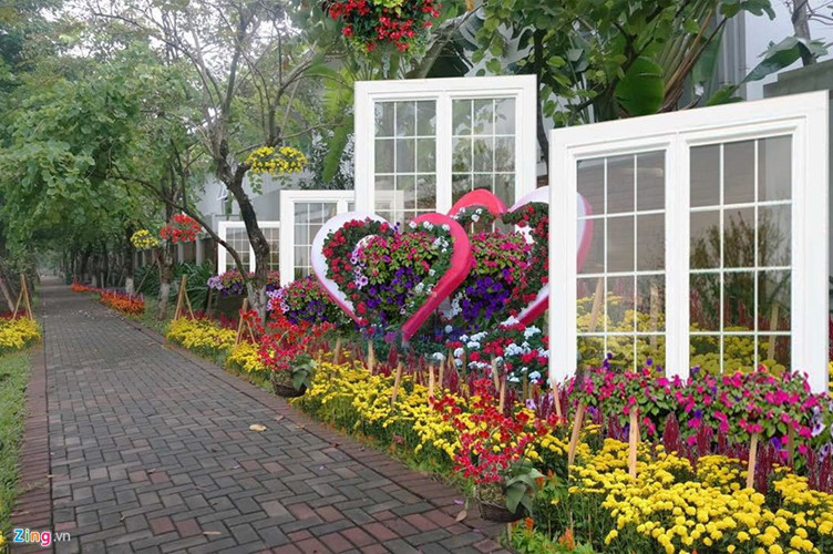 Sidewalks and villas in Hanoi scrupulously decked out with gorgeous decadent cascading flower arrangements to welcome Tet Lunar New Year