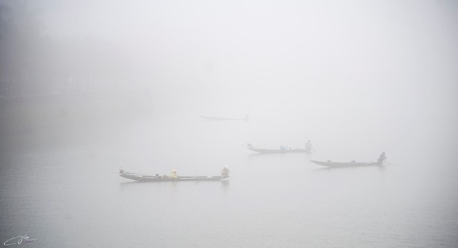 Small fishing boats in the fog