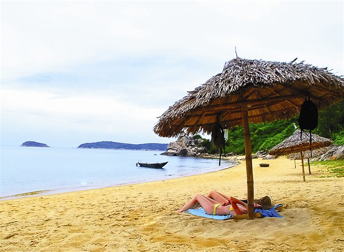 Tourists relax on a beach onn Cu Lao Cham