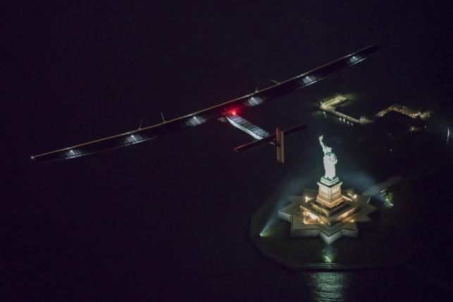  Solar Impulse 2, the solar airplane, piloted by Swiss adventurer Andre Borschberg, flies over the Statue of Libery in in New York, U.S. June 11, 2016 shortly before landing at John F. Kennedy airport. Leg 14 was the shortest so far on the planes trip around the globe. ...