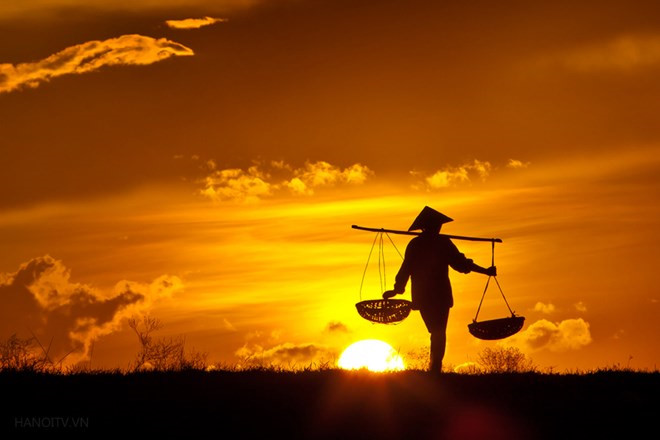 Farmer returning from fields at dusk