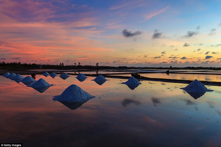 Vietnam has many attractions, its salt fields being one. During the day, it's busy with harvesters who together amass an annual salt production of around 700,000 tons, but as the sun goes down, it's a shrine to tranquillity