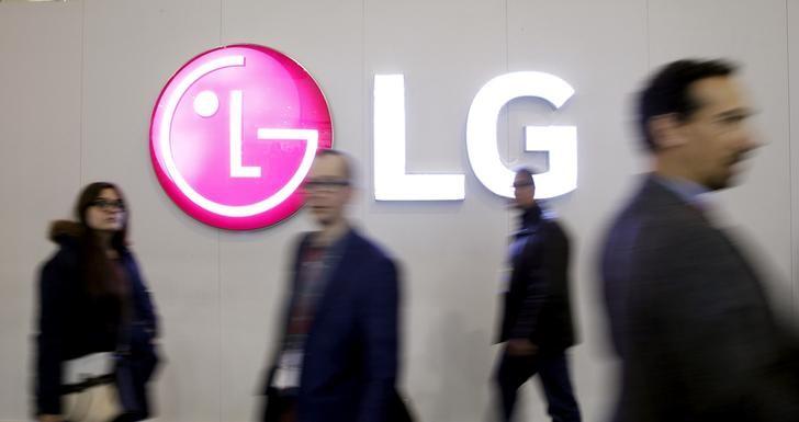 People walk past a LG Electronics logo during the Mobile World Congress in Barcelona, Spain, February 25, 2016.