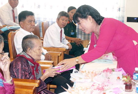 Chủ tịch Hội Liên hiệp phụ nữ huyện Nhơn Trạch Võ Thị Hoa tặng quà bà mẹ Việt Nam anh hùng tại đại hội. Ảnh: N.Sơn