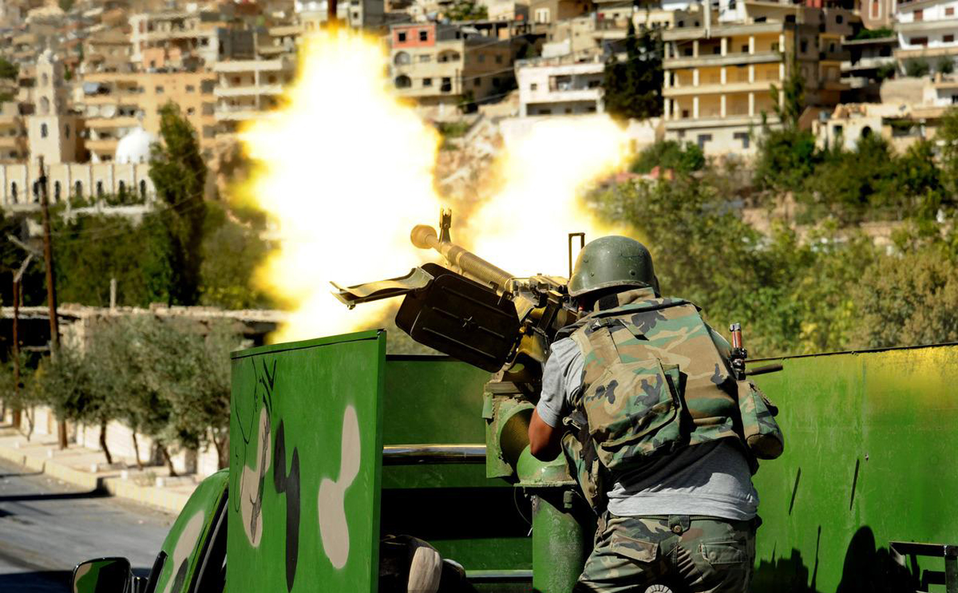 Quân chính phủ Syria giao tranh với phe nổi dậy tại làng Maaloula hôm 30-9 - Nguồn AP