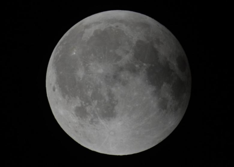 The moon is seen during its final eclipse over Los Angeles, California, early April 15, 2014.