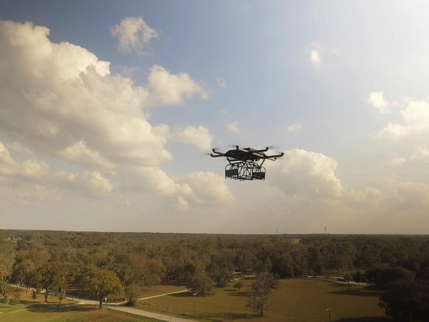 The drone carries parcels in a suspended cage, which can be reloaded each time it docks on the lorry