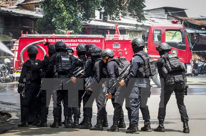 Cảnh sát chống khủng bố Indonesia bao vây tòa nhà nơi kẻ tình nghi khủng bố ẩn náu sau vụ nổ tại Bandung. (Nguồn: EPA/TTXVN)