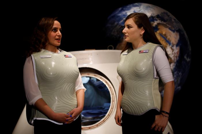 Women wearing prototypes of Stemrad's new protective vest, Astrorad, stand near Russian spacecraft, Excalibur-Almaz Space Capsule, during a demonstration for Reuters, at Madatech, National Museum of Science Technology and Space in Haifa, Israel February 23, 2017.