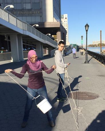 Researchers sample water from the East River off New York as part of a study of fish DNA that is helping scientists to track migrations of species such as herring and bass to the region, in New York, U.S., October 30, 2015. 