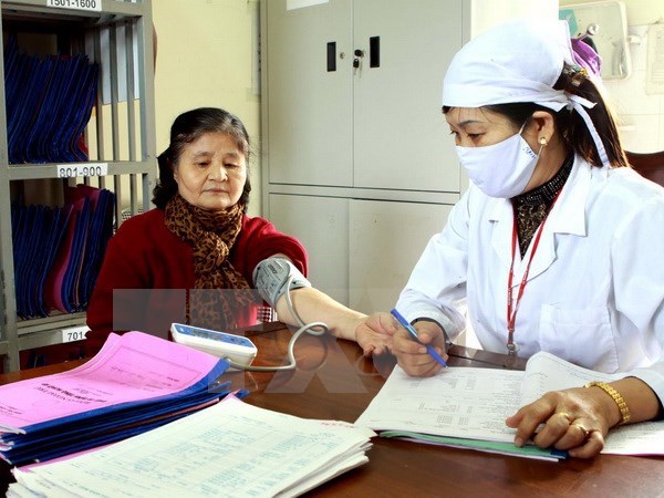 A woman receives blood pressure check