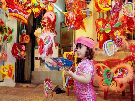 A girl is fascinated with the colourful lanterns.