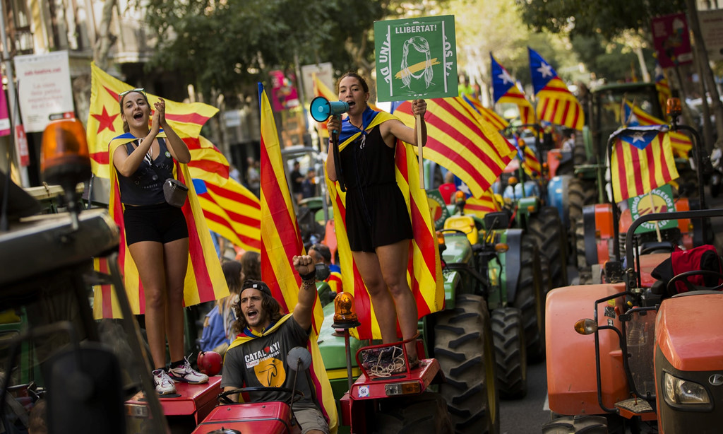 Nông dân treo lá cờ độc lập của xứ Catalan trên đầu máy kéo trong một cuộc biểu tình ở Barcelona - Nguồn AP