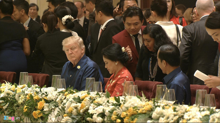 President Donald Trump sits next to Indonesian President Joko Widodo and his wife.