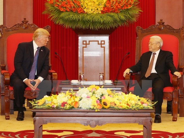 General Secretary of the Communist Party of Vietnam Nguyen Phu Trong (R) receives US President Donald Trump