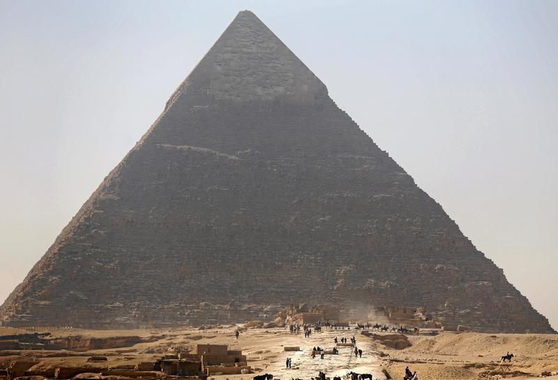 Tourists visit the Pyramid of Khufu, the largest of the Great Pyramids of Giza, on the outskirts of Cairo, Egypt on March 2, 2016.