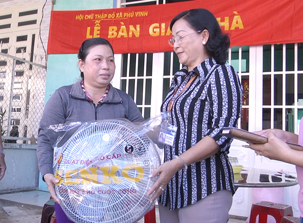 Presenting charity house to poor household