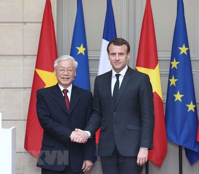 General Secretary of the Communist Party of Vietnam Central Committee Nguyen Phu Trong (L) and French President Emannuel Macron