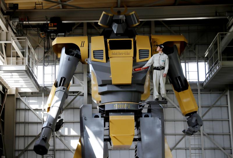 Sakakibara Kikai's engineer Go Sakakibara poses with the bipedal robot Mononofu during its demonstration at its factory in Shinto Village, Gunma Prefecture, Japan, April 12, 2018. REUTERS/Kim Kyung-Hoon