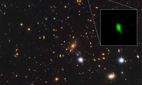 A galaxy located 13.28 billion light-years away is giving scientists new insight into the early history of the universe, with the detection of the oldest-known evidence of oxygen. This Hubble Space Telescope image shows the galaxy cluster MACS J1149.5+2223 and the inset image shows the galaxy MACS1149-JD1, with the detected oxygen distribution in green, observed with the Atacama Large Millimeter/submillimeter Array (ALMA), an astronomical interferometer of radio telescopes in the Atacama desert of northern Chile. The image was released May 16, 2018. Courtesy ALMA (ESO/NAOJ/NRAO), NASA/ESA Hubble Space Telescope, W. Zheng (JHU), M. Postman (STScI), the CLASH Team, Hashimoto et al/Handout via REUTERS 