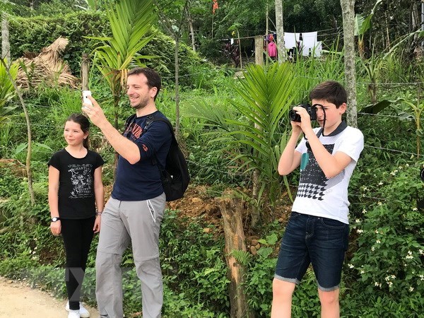 Foreign tourists take photos in Don village, the Central Highlands province of Dak Lak