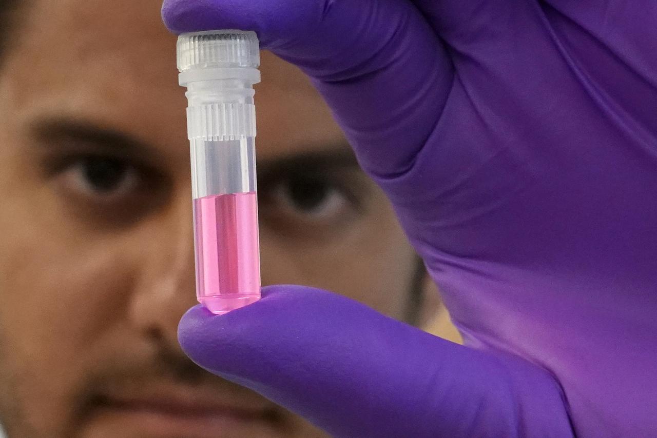 Andrew Schweighardt holds a vial with a DNA sample at the office of the Chief Medical Examiner of New York during an event in New York City, New York, U.S., September 6, 2018.