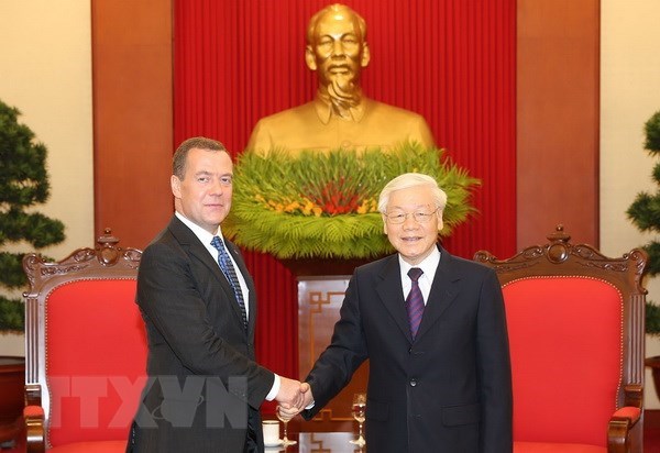 General Secretary of the Communist Party Central Committee (CPVCC) and President Nguyen Phu Trong (R) and visiting Russian Prime Minister Dmitry Medvedev