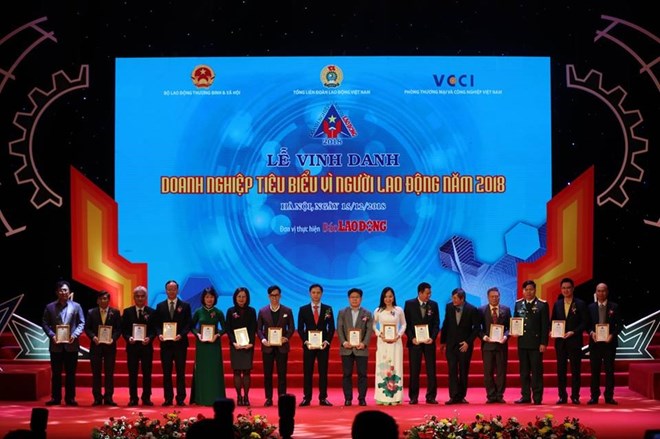 Sixty firms which stood out for their material and spiritual care for labourers are honoured at a ceremony on December 15. (Photo: laodong.vn)