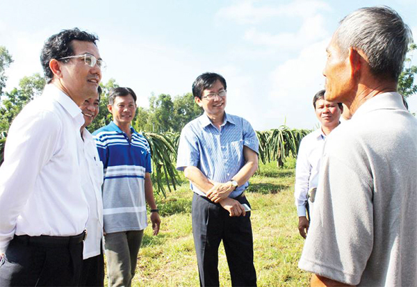 Phó chủ tịch UBND tỉnh Võ Văn Chánh (bìa trái) thăm mô hình trồng thanh long ruột đỏ cho lợi nhuận cao tại huyện Thống Nhất