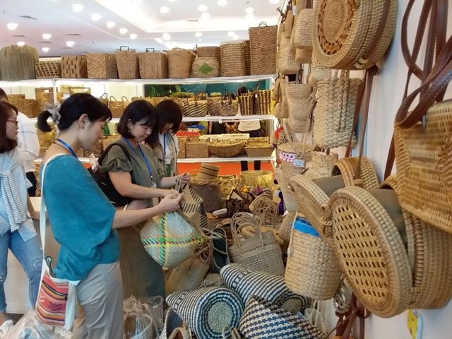 Customers browse handicraft products at a shop in