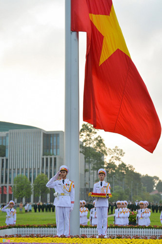 The national flag flutters in the wind as it flies above Ba Dinh Square.