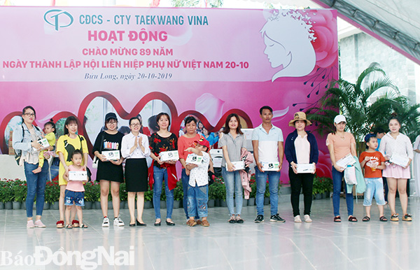 Chủ tịch Công đoàn khu công nghiệp Biên Hòa Nguyễn Thị Tuyết tặng phần thưởng bốc thăm may mắn cho người lao động.
