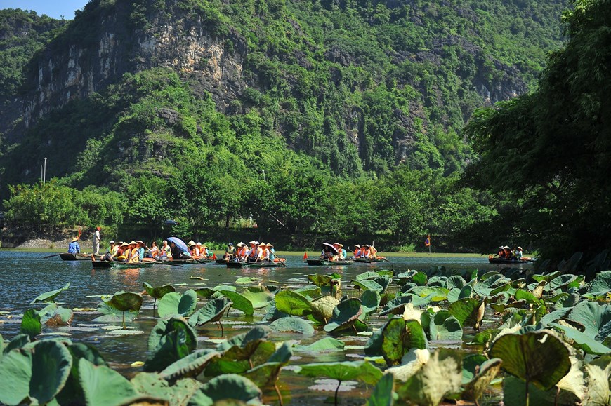   Experiencing a boat trip through caves in Trang An