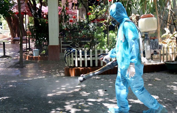 A medical workers is spraying a residential area in Binh Thuan province with disinfectant. 