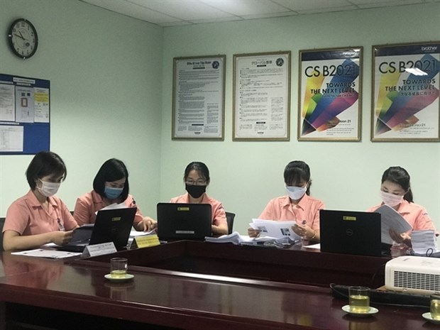 Vietnam Social Security staff deploy the electronic record transaction system at Brothers Vietnam Company in Cam Giang district, Hai Duong province. (Photo: VNA) 