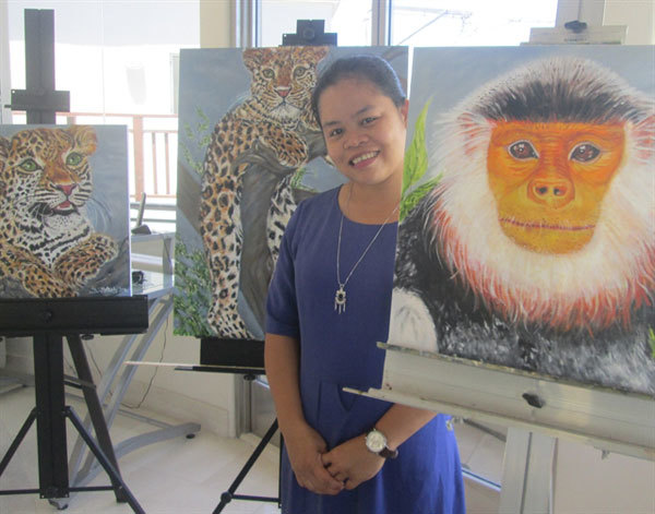 Le Thi Trang poses for a photo at an exhibition on the endangered red-shanked douc langurs (Pygathrix nemaeus) in Da Nang. She and nine other conservationists from around the world have been named ‘Hotspot Heroes’ for their efforts to protect the world’s biodiversity hotspots. — Photo courtesy Le Thi Trang