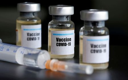 FILE PHOTO: Small bottles labeled with a "Vaccine COVID-19" sticker and a medical syringe are seen in this illustration taken taken April 10, 2020.