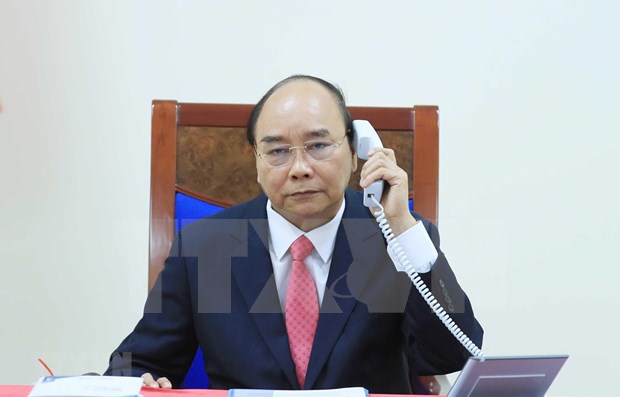 PM Nguyen Xuan Phuc talks on the phone with his Singaporean counterpart.