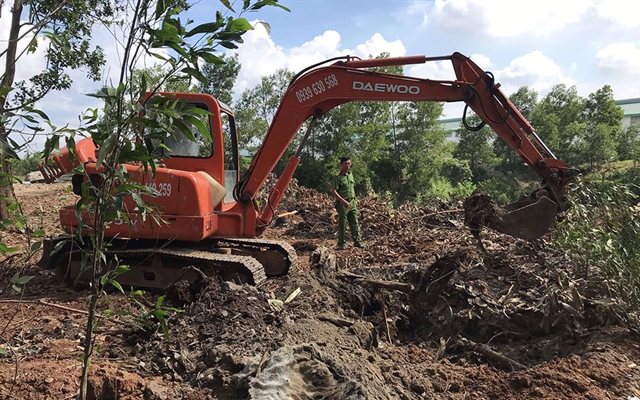 Police in the southern province of Đồng Nai last week found tonnes of solid waste buried in the area of Shing Mark Vina Ltd Company - a wooden furniture making company. — Photo nhandan.com.vn