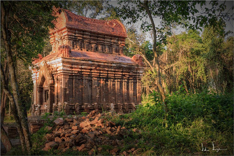 A tower temple stands tall amid dense forest. 