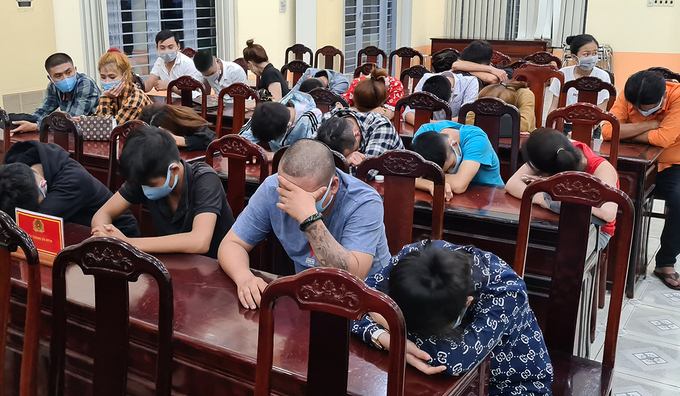 People attending a drug-fueled party are held at a police station in Dong Nai Province, southern Vietnam, August 2, 2020. 