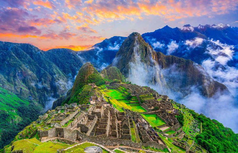 Machu Picchu of Peru  “Machu Picchu's network of dry-stone walls and agricultural terraces etch the mountaintop site, surrounded by the Andean peaks, making it an astonishing place to soak up the sunrise which bathes the surrounding landscape in glorious colours”.