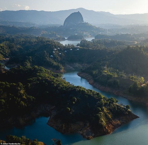 In this amazing shot taken in Colombia, viewers can see the 10-million-tonne El Peñon de Guatape rock in the background, a site that features a stone staircase embedded into a large crevice.