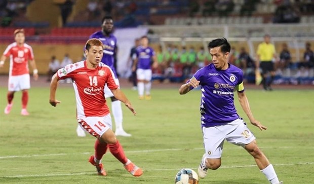 Nguyen Van Quyet (right) scores a hat-trick in Hanoi FC's 5-1 win against HCM City FC in the National Cup semi-final.