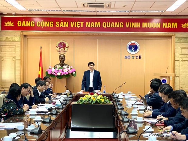 Minister of Health Nguyen Thanh Long (standing) at the meeting with Vietnamese vaccine producers on December 5.