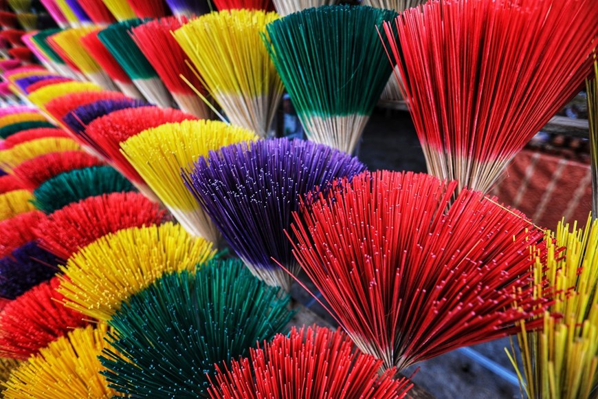 Incense with colourful sticks look like a vibrant blooming flower.