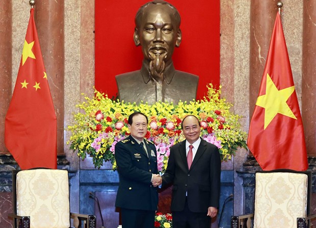 President Nguyen Xuan Phuc (R) welcomes the Chinese Minister of National Defence, Sen. Lt. Gen. Wei Fenghe, in Hanoi on April 26.